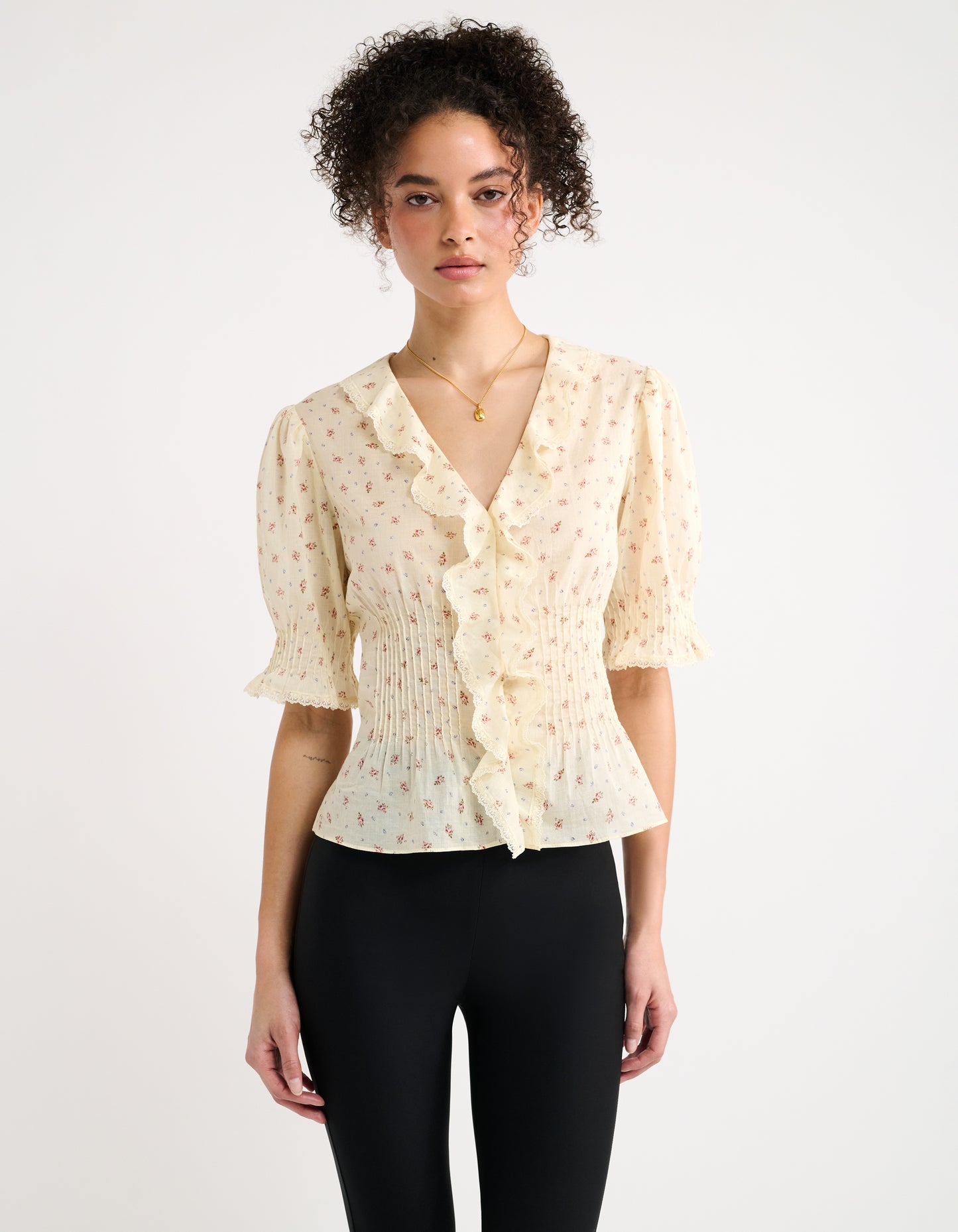 Ruffles, lace trim, a dainty floral print, and hand-sewn micro pintucks