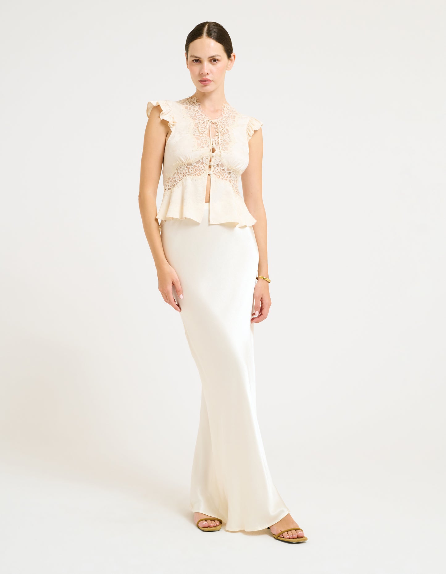 Vintage Inspired Blouse with Fabric covered button up placket and Lace trim.
Ruffle sleeve short sleeve and Micro ties at center front neckline paired with Archive Maxi Skirt