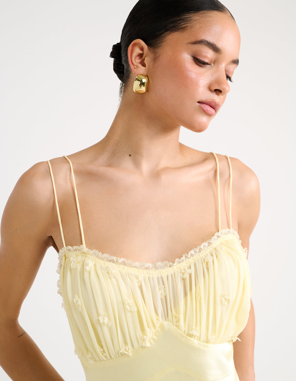 Lace edge around neckline and chiffon tuffs on chest