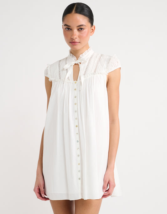 Lace trim at chest and functional buttons down the front Cotton mini dress
