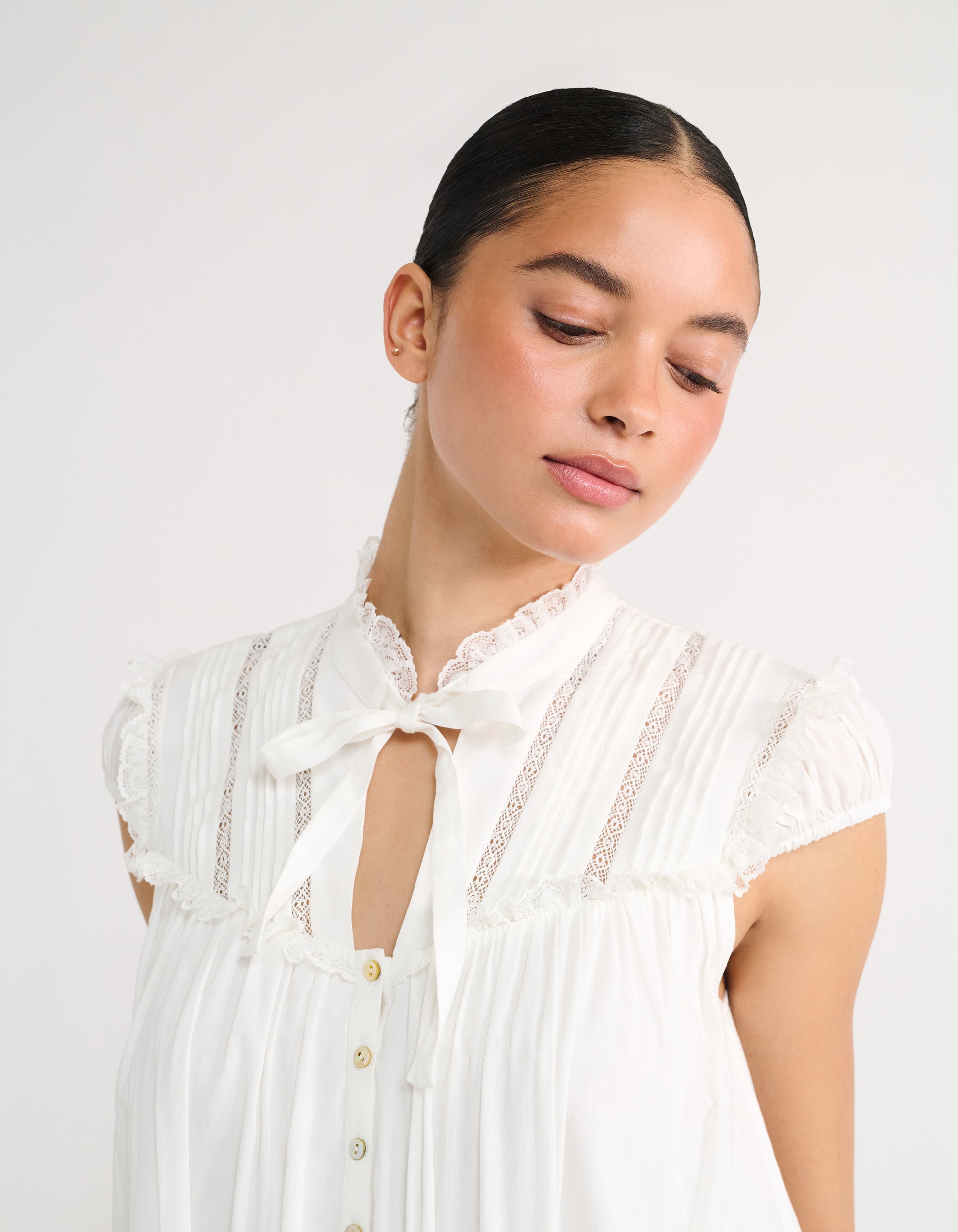 mandarin collar with adjustable bow detail