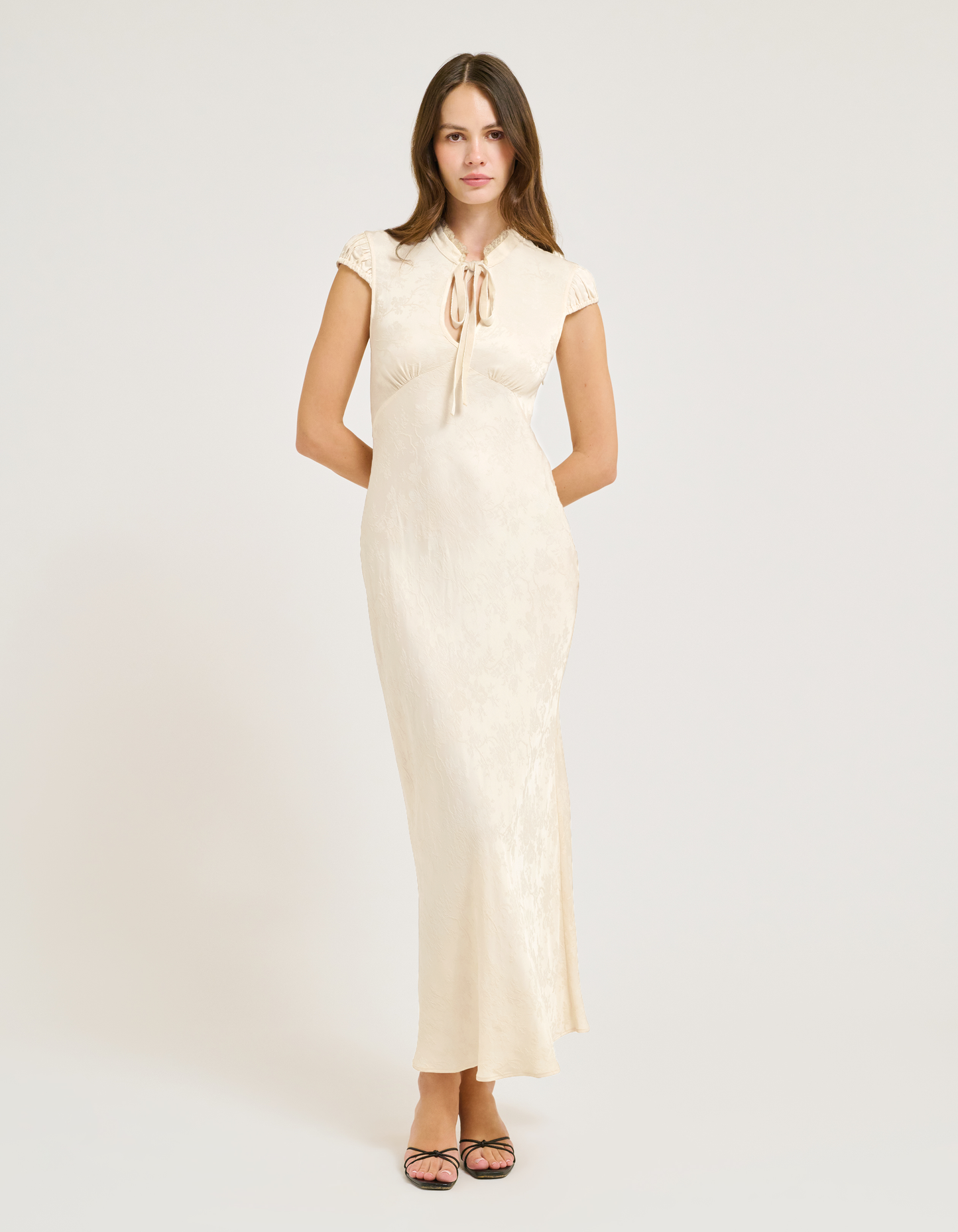 satin jacquard maxi dress with Lace collar and velvet bow at center.
Cap Sleeves.