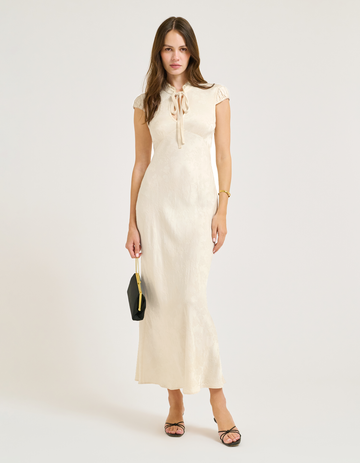 satin jacquard maxi dress with Lace collar and velvet bow at center.
Cap Sleeves.