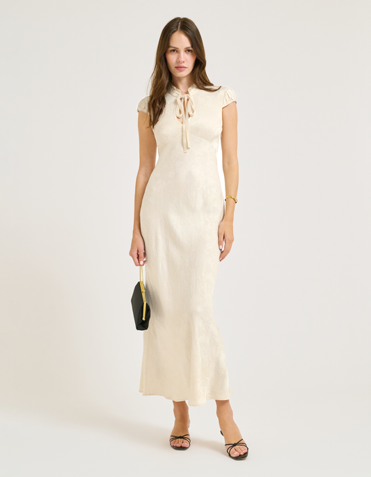 satin jacquard maxi dress with Lace collar and velvet bow at center.
Cap Sleeves.