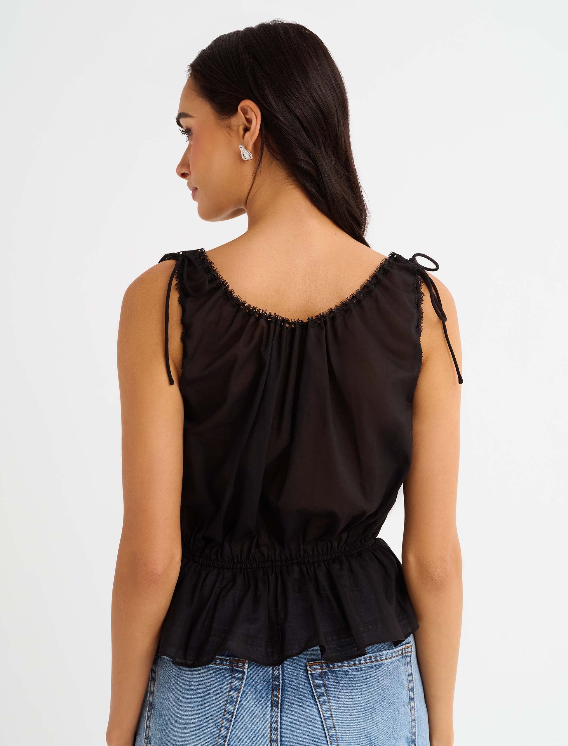 Back view of Cotton Peplum Tank top with lace trims, and micro ties.