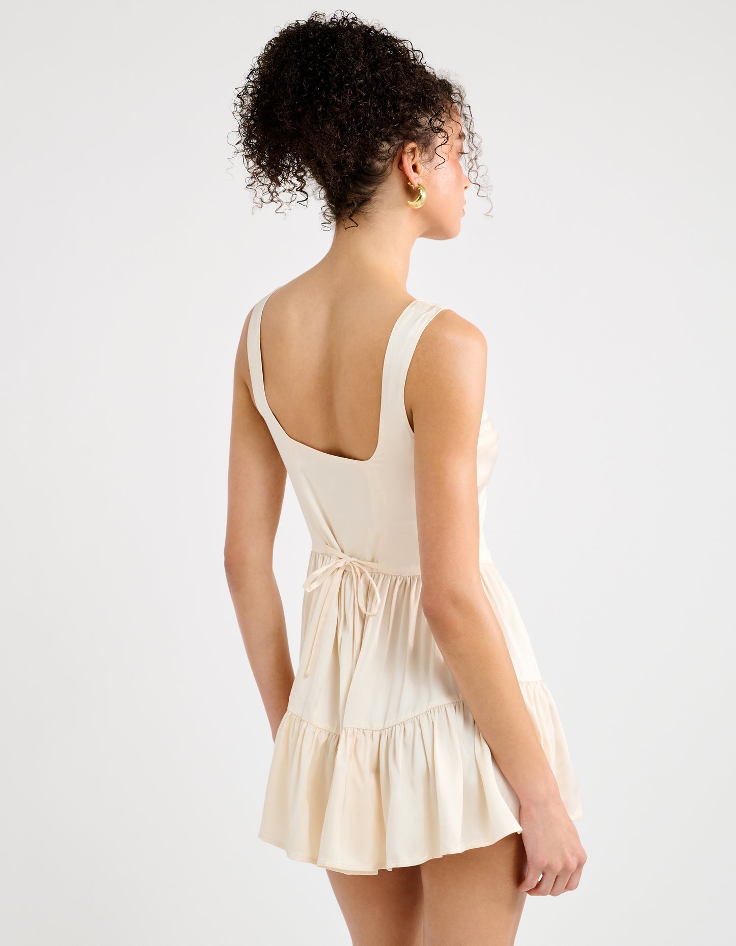 Back of Romper with string tied in bow at lower back