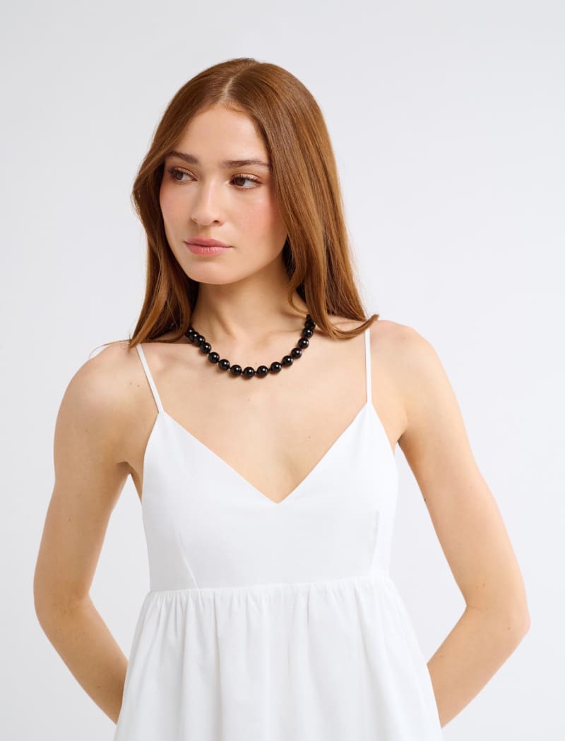 white midi summer dress Rihoas Vintage Halter with an Open Back & Bow Sleeve Length White Tie-Back Halter Midi Dress